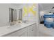 Bathroom with double sinks, white cabinets, and a large mirror at 2416 Cadenza Cir, Dacula, GA 30019