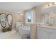 Bathroom with double sinks, a soaking tub, and large mirrors at 2416 Cadenza Cir, Dacula, GA 30019