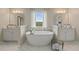 Spa-like bathroom with double vanities and a free-standing tub at 2416 Cadenza Cir, Dacula, GA 30019