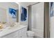 Clean bathroom with white vanity, shower/tub combo, and blue accents at 2416 Cadenza Cir, Dacula, GA 30019