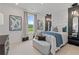 Spacious bedroom with a plush bed, window seat, and natural light at 2416 Cadenza Cir, Dacula, GA 30019