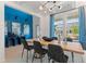 Modern dining room with a blue accent wall and wood table at 2416 Cadenza Cir, Dacula, GA 30019