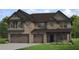 Two-story brick home with brown roof and attached garage at 2416 Cadenza Cir, Dacula, GA 30019