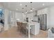 Open concept kitchen with white cabinets and island at 2416 Cadenza Cir, Dacula, GA 30019