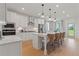 Modern white kitchen with island and stainless steel appliances at 2416 Cadenza Cir, Dacula, GA 30019
