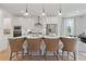 Island kitchen with white cabinets and breakfast bar at 2416 Cadenza Cir, Dacula, GA 30019