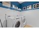 Laundry room with Whirlpool washer and dryer and stylish wall decor at 2416 Cadenza Cir, Dacula, GA 30019