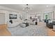 Comfortable living area featuring a large sectional sofa and wood floors at 2416 Cadenza Cir, Dacula, GA 30019