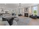 Open living space with a modern sectional sofa and fireplace at 2416 Cadenza Cir, Dacula, GA 30019