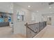 Open loft area with gray and blue walls and a staircase at 2416 Cadenza Cir, Dacula, GA 30019