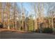 View of the backyard of the home showing a wooded area and a well maintained lawn at 4596 Birch Way, Loganville, GA 30052
