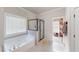 Bathroom with soaking tub, glass-enclosed shower, and walk-in closet at 4596 Birch Way, Loganville, GA 30052