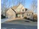 Inviting two-story home with brick and siding exterior, showcasing a well-maintained lawn and a charming front porch at 4596 Birch Way, Loganville, GA 30052