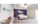 Bright bedroom with dark accent wall, tray ceiling, and carpeted floor at 4596 Birch Way, Loganville, GA 30052