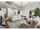 Living room with hardwood floors, coffered ceiling, and comfortable seating at 5245 Wilshire Xing, Cumming, GA 30040