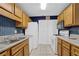 Kitchen with wood cabinets, blue tile, and white appliances at 2105 Country Park Dr, Smyrna, GA 30080