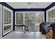 Sunroom with tiled floor, dark walls, and multiple windows at 2105 Country Park Dr, Smyrna, GA 30080