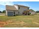 Spacious backyard featuring a covered patio, storage shed, and well-manicured lawn at 220 Seth Ter, Mcdonough, GA 30252