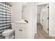 The bathroom features a single vanity and toilet with patterned shower curtain at 220 Seth Ter, Mcdonough, GA 30252