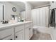 This bathroom boasts a double vanity, large mirror, and a bathtub with a shower at 220 Seth Ter, Mcdonough, GA 30252