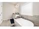 Bathroom with soaking tub and gray tile floors at 220 Seth Ter, Mcdonough, GA 30252