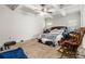 This bedroom features a ceiling fan, a comfortable bed, and neutral-toned walls at 220 Seth Ter, Mcdonough, GA 30252