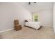 Bright bedroom features neutral walls, plush carpet, large window, and comfortable furnishings at 220 Seth Ter, Mcdonough, GA 30252