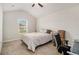 Bright bedroom with a bed, chair, and window at 220 Seth Ter, Mcdonough, GA 30252