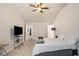 The bedroom has carpet floors, a ceiling fan, and view into the ensuite bathroom at 220 Seth Ter, Mcdonough, GA 30252