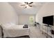 Bright bedroom features neutral walls, plush carpet, a desk, and comfortable bedding at 220 Seth Ter, Mcdonough, GA 30252