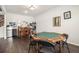 Entertaining game room featuring hardwood floors, game table, bar, and mini fridge at 220 Seth Ter, Mcdonough, GA 30252