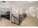 Upstairs loft area with railing, carpeted flooring, and view to a downstairs office area at 220 Seth Ter, Mcdonough, GA 30252