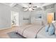 This main bedroom features a tray ceiling, ceiling fan, and ensuite bathroom with a soaking tub at 220 Seth Ter, Mcdonough, GA 30252