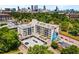 Aerial view of apartment building with street art, surface parking, and city skyline in the background at 563 Memorial Se Dr # 211, Atlanta, GA 30312