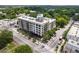 Aerial view of apartment building, surrounded by lush trees and situated near city streets at 563 Memorial Se Dr # 211, Atlanta, GA 30312