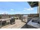 Outdoor rooftop kitchen with stainless grill, granite counters, dining table, and city views at 563 Memorial Se Dr # 211, Atlanta, GA 30312