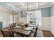 Elegant dining room with coffered ceiling, and hardwood floors at 5750 Sutters Vw, Cumming, GA 30028