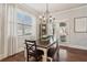 Charming dining room features hardwood floors and a chandelier at 5750 Sutters Vw, Cumming, GA 30028