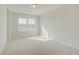 Bright, carpeted bedroom with large windows and natural light at 628 Leafy Branch Way, Mcdonough, GA 30253