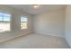 Bedroom featuring neutral carpet, two windows that allow plenty of natural light into the room at 628 Leafy Branch Way, Mcdonough, GA 30253