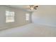 Bedroom showcasing neutral carpet, large windows providing great natural light, and a ceiling fan at 628 Leafy Branch Way, Mcdonough, GA 30253