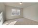 Spacious bedroom featuring neutral carpeting, two windows, and neutral paint at 628 Leafy Branch Way, Mcdonough, GA 30253