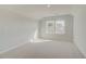 Bedroom featuring neutral carpeting and dual windows providing natural light at 628 Leafy Branch Way, Mcdonough, GA 30253