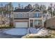 Two-story brick home with a white garage door and landscaping at 628 Leafy Branch Way, Mcdonough, GA 30253