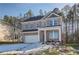 Two-story brick home with a white garage door and landscaping at 628 Leafy Branch Way, Mcdonough, GA 30253