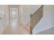 Open Foyer with light wood floors and staircase with black metal balusters at 628 Leafy Branch Way, Mcdonough, GA 30253