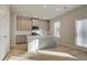 Kitchen featuring gray cabinets, an island, stainless steel appliances, and an abundance of natural light at 628 Leafy Branch Way, Mcdonough, GA 30253