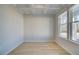 Bright, versatile room featuring a coffered ceiling, natural light, and light hardwood flooring at 628 Leafy Branch Way, Mcdonough, GA 30253