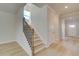 Modern staircase with metal railing and hardwood flooring at 628 Leafy Branch Way, Mcdonough, GA 30253