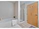 Bathroom with soaking tub, shower, and light tile at 660 Glen Iris Ne Dr # 204, Atlanta, GA 30308